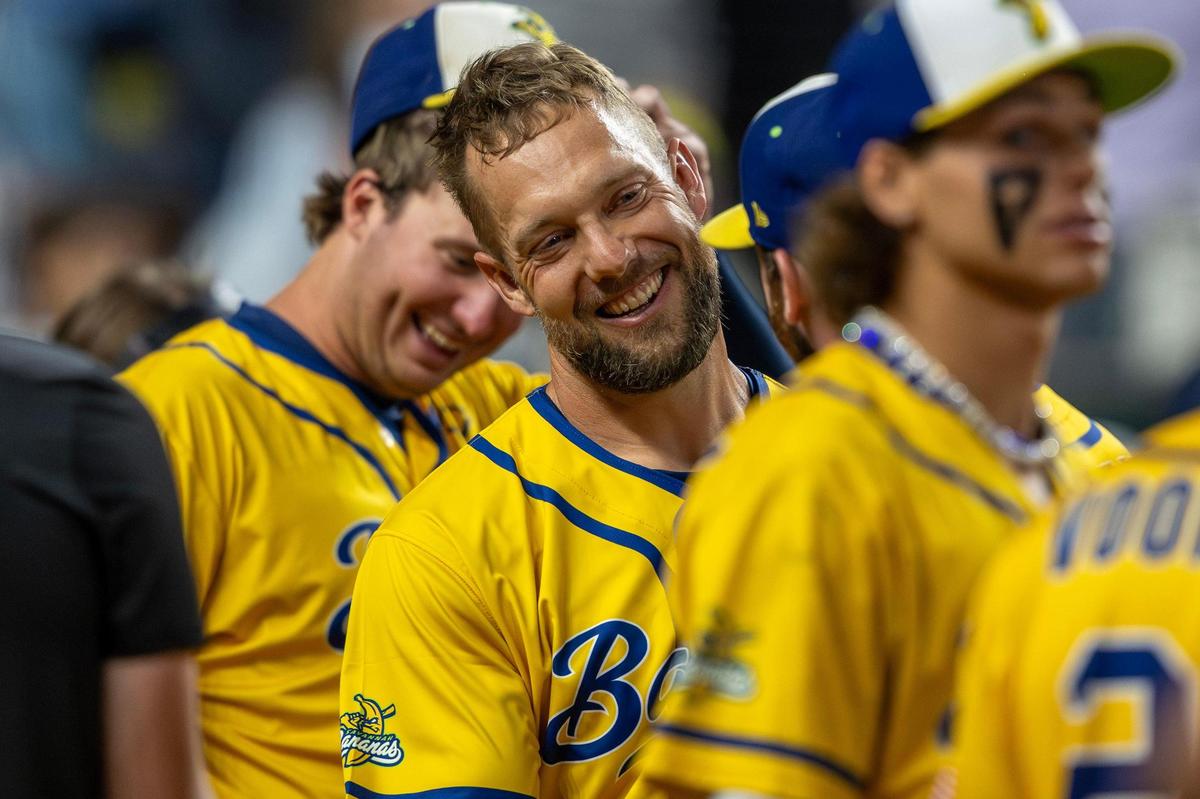 Former Kansas City Royals outfielder Alex Gordon, introduced as the golden batter, smiles after striking out in the eighth inning.