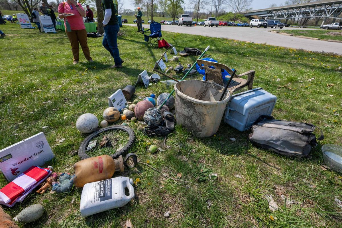 Items found during Saturday’s cleanup are piled in front of signs designating various categories to be judged for the best piece of trash in that category.