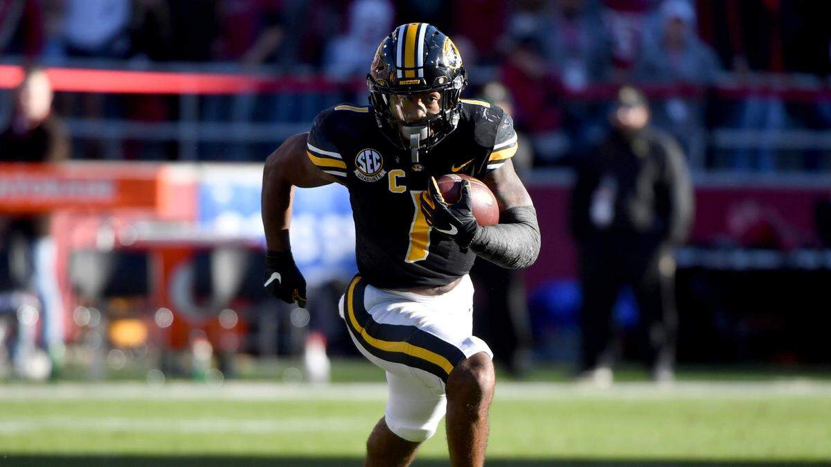 Missouri running back Tyler Badie (1) runs against Arkansas during an NCAA college football game Friday, Nov. 26, 2021, in Fayetteville, Ark. (AP Photo/Michael Woods)