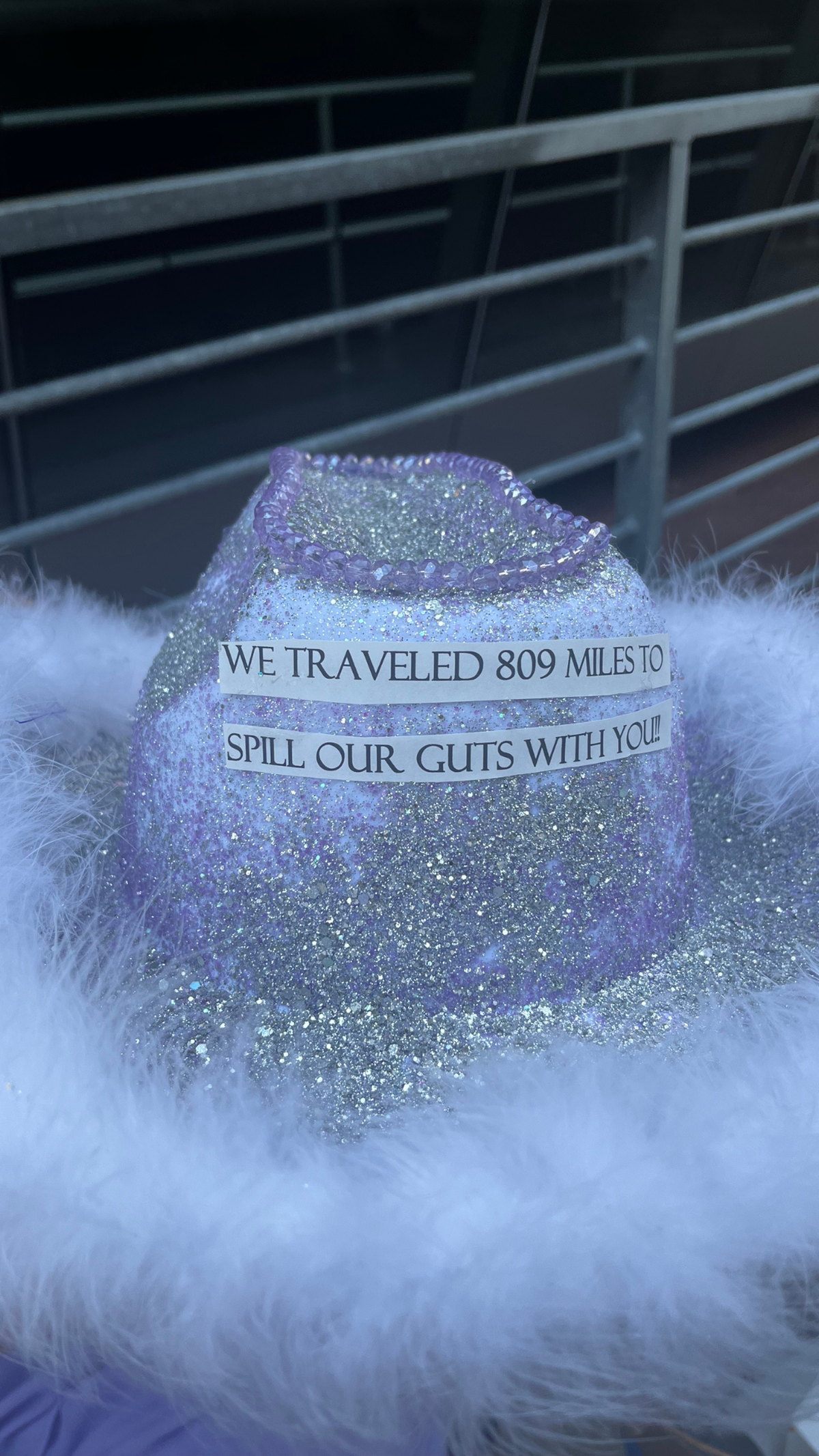 A fan’s hat for Olivia Rodrigo’s Kansas City concert touts the distance they traveled for the show.