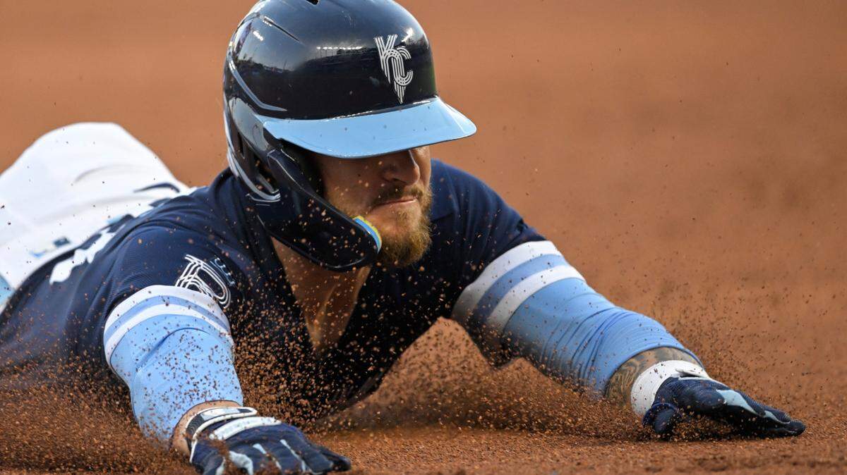 Kansas City Royals’ Kyle Isbel dives into third base for a triple against the Boston Red Sox during the second inning of a baseball game Friday, Aug. 5, 2022, in Kansas City, Mo. (AP Photo/Reed Hoffmann)