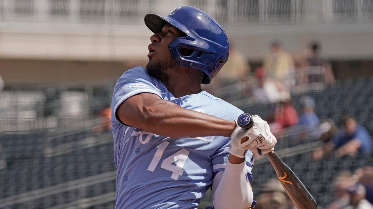 Kansas City Royals’ Edward Olivares bats during the first inning of a spring training baseball game against the Texas Rangers Friday, March 25, 2022, in Surprise, Ariz. (AP Photo/Charlie Riedel)