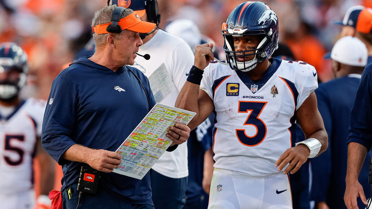 Denver Broncos head coach Sean Payton talks with quarterback Russell Wilson (3) in the fourth quarter against the Washington Commanders at Empower Field at Mile High.