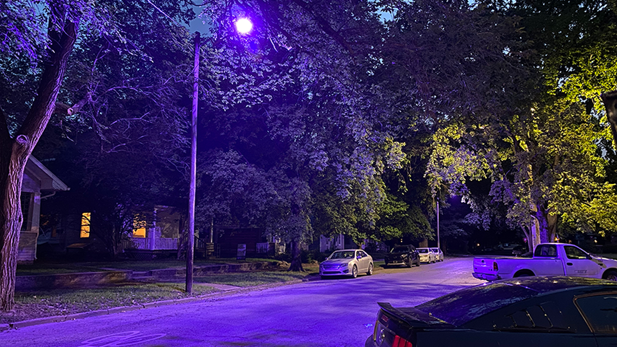 A purple-hued LED streetlight is seen in Manhattan, Kansas in July of 2021. A manufacturing defect in new LED bulbs is causing streetlights to turn purple in cities across North America, including in Kansas City.