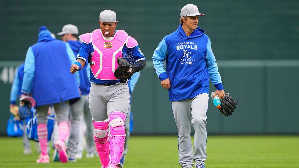 Kansas City Royals catcher Salvador Perez (13) and pitcher Zach Greinke (23) walk to the dugout from the bullpen prior to a game against the Baltimore Orioles t Oriole Park at Camden Yards.