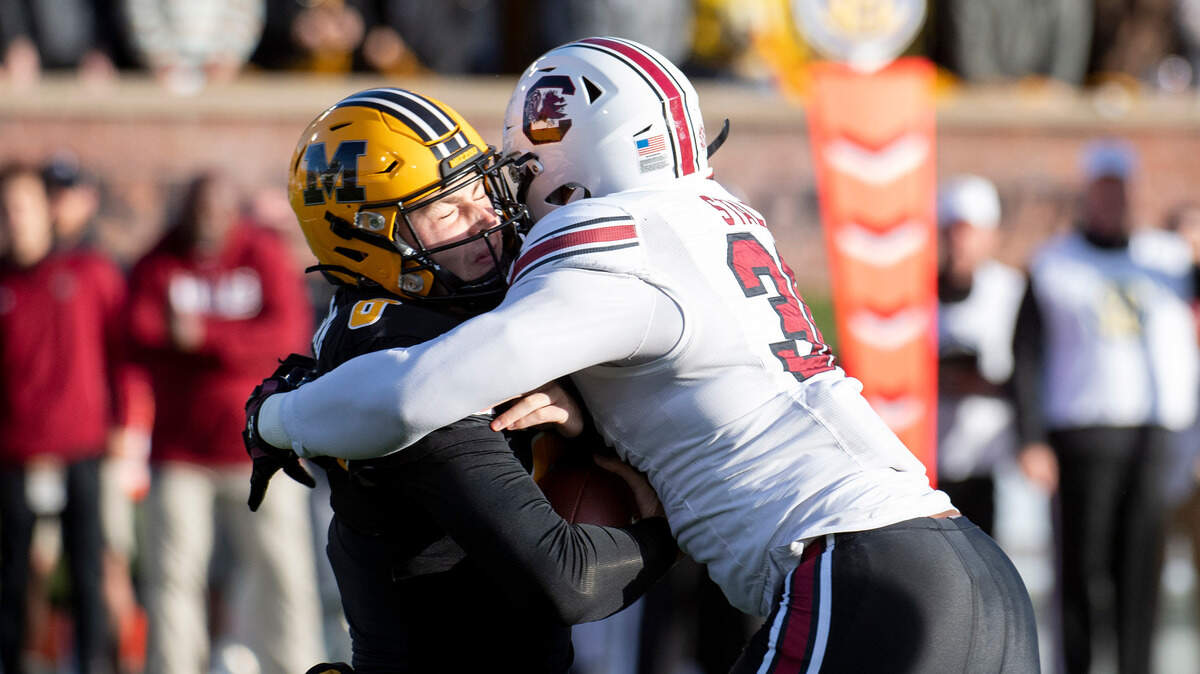 Missouri quarterback Connor Bazelak, left, is sacked by South Carolina linebacker Damani Staley, right, during the first quarter of an NCAA college football game Saturday, Nov. 13, 2021, in Columbia, Mo. (AP Photo/L.G. Patterson)