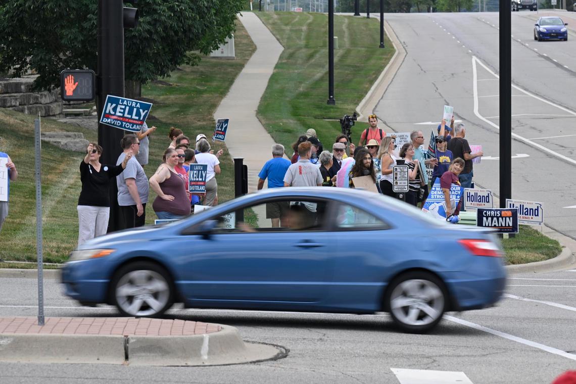 Protesters gathered off Ridgeview Road outside a rally at Embassy Suites in Olathe on Sunday, where Florida Gov. Ron DeSantis campaigned for Attorney General Derek Schmidt, the GOP nominee for Kansas governor.