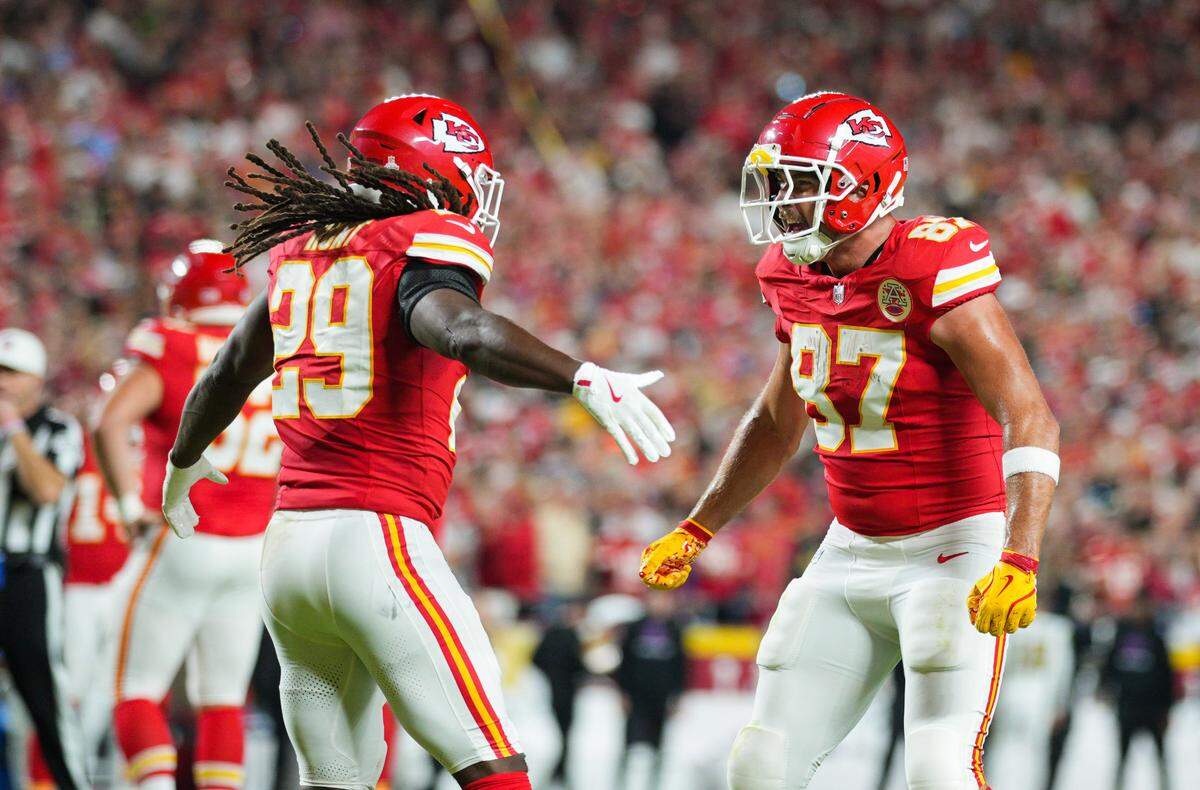 Oct 7, 2024; Kansas City, Missouri, USA; Kansas City Chiefs running back Kareem Hunt (29) celebrates with tight end Travis Kelce (87) after scoring a touchdown during the first half against the New Orleans Saints at GEHA Field at Arrowhead Stadium. Mandatory Credit: Jay Biggerstaff-Imagn Images