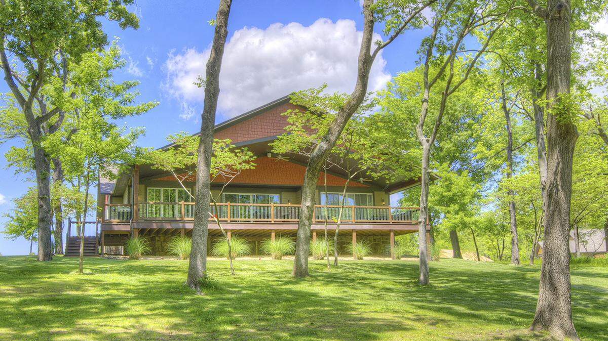 Our custom homes are nestled in-between tall mature trees and back up to the shores of Grand Lake! This home enjoys the Lakeview off the expansive deck and the sounds of running water from the waterfall feature along the developments walking trails. 