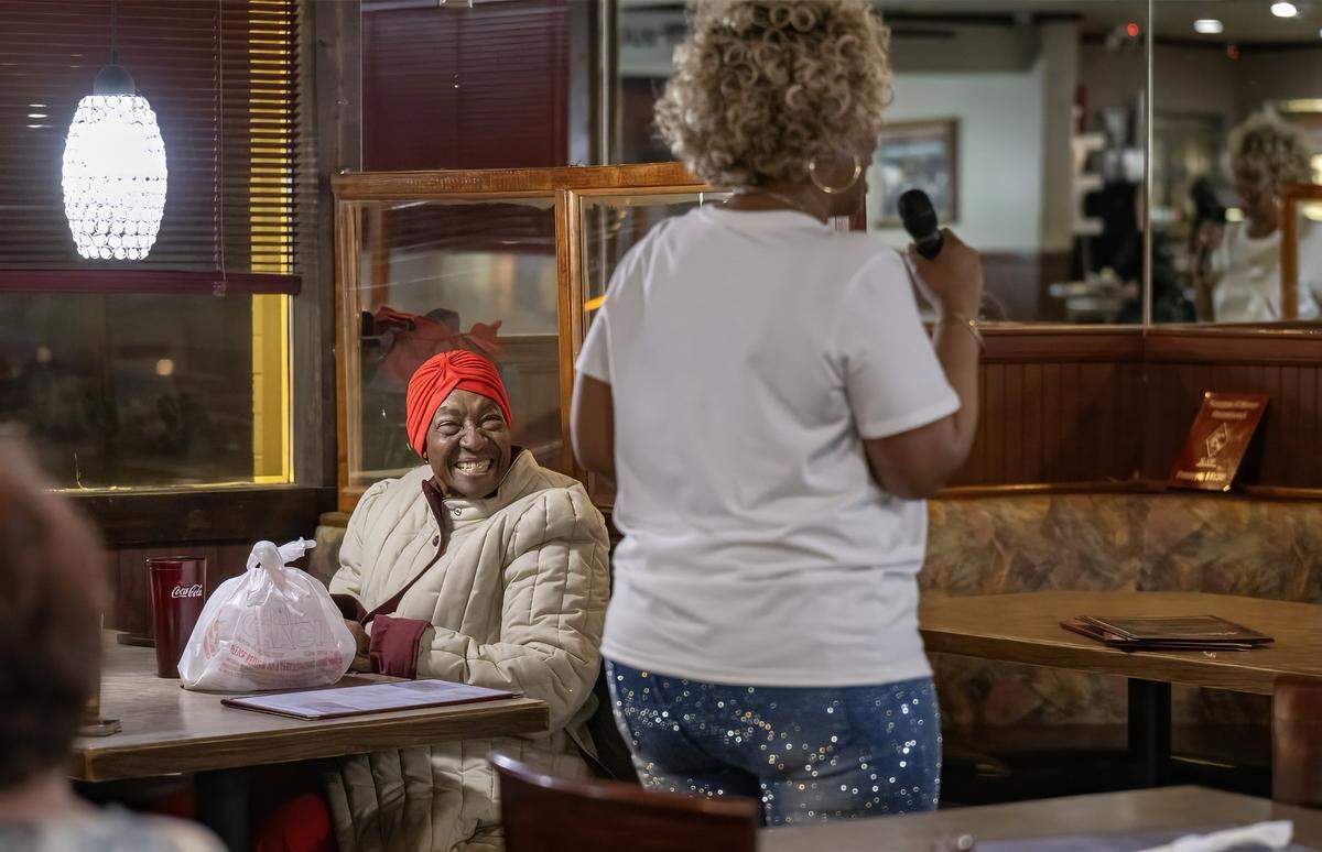 Dinner patron Beverly Crawford of Kansas City looks on a Denise “Ms. Niecie” Ward sings during “Dinner & A Show” on Friday, Feb. 6, 2026, at Niecie's Restaurant in Kansas City.