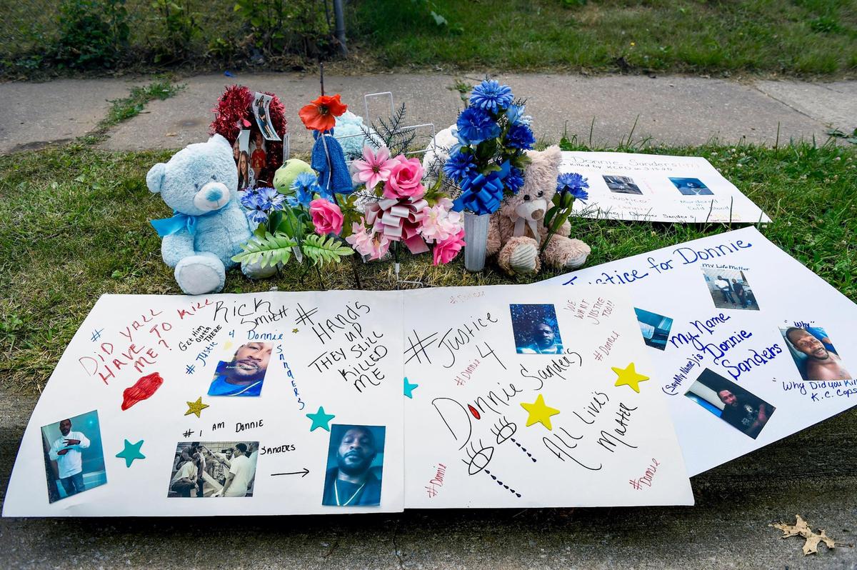 A memorial for Donnie Sanders, 47, sits on the sidewalk at E. 52nd Street and Wabash Avenue in Kansas City. The location is near where Sanders, who was unarmed, was fatally shot on March 13, by a Kansas City police officer after fleeing a traffic stop.