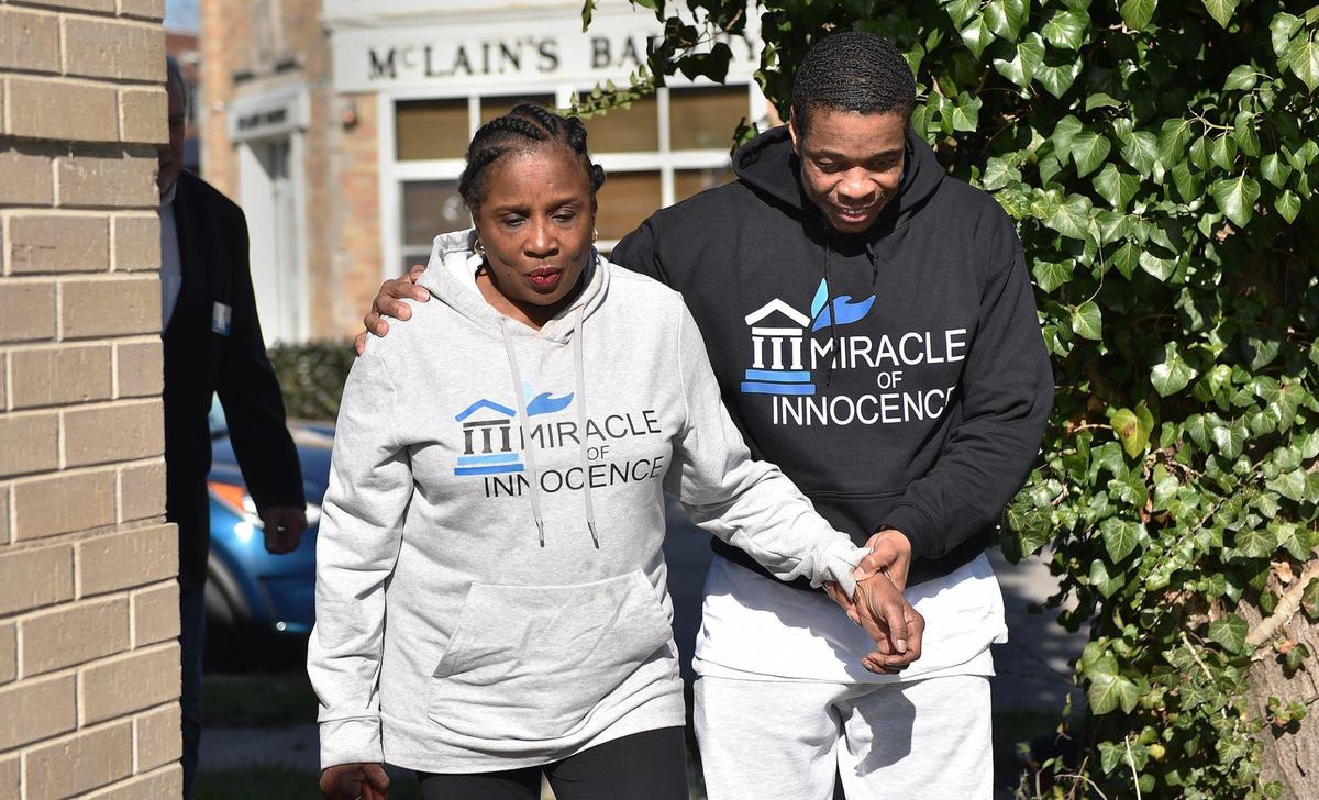 Keith Carnes leads his mother Eve Moffatt to a press conference outside his attorney’s office. Carnes was freed from prison Monday, April 11, 2022, after 18 years. The prosecutor’s office declined to file charges after the Missouri Supreme Court threw out his conviction for murder and armed criminal action.