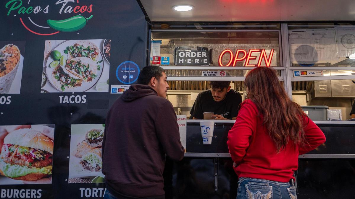 Customers order from Paco’s Tacos, a food truck at 18th Street and Central Avenue in Kansas City, Kansas.