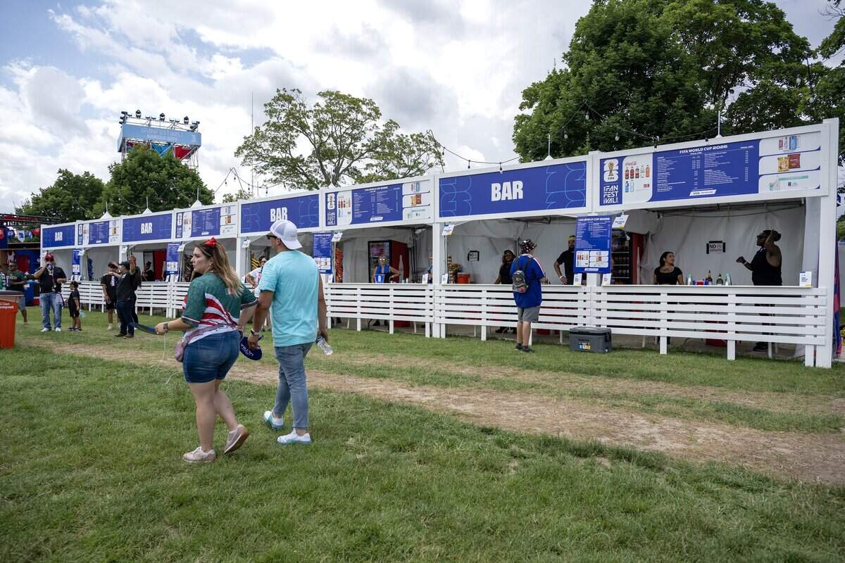 Soccer fans walk past beverage booths during the FIFA Fan Festival on Thursday, June 11, 2026, in Kansas City.