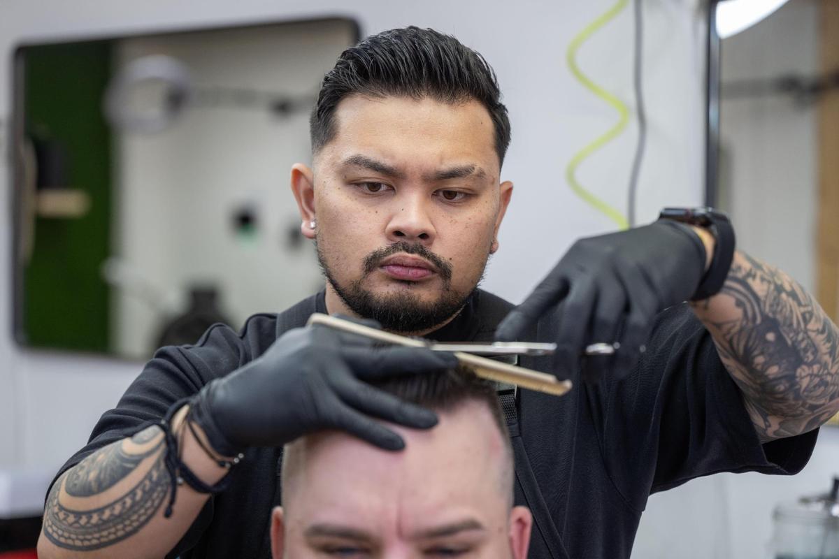 Josh Pacubas cuts Clint Rosewell’s hair at his barbershop, Dé Luxe Studios, in Mission.
