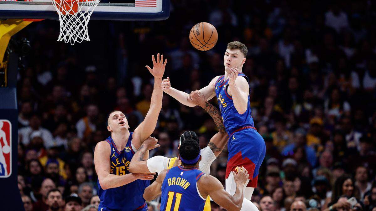 Nuggets guard Christian Braun (0) knocks the ball away from Lakers forward Anthony Davis (3) during Game 1 of the Western Conference Finals at Ball Arena in Denver on May 16, 2023.
