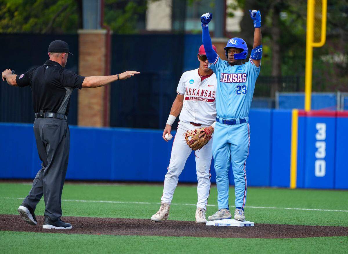 Kansas Jayhawks infielder Dariel Osoria (23) celebrates getting to base during a game against the Arkansas Razorbacks in the NCAA baseball regionals at Hoglund Ballpark in Lawrence, Kansas, on Sunday, May 31, 2026.