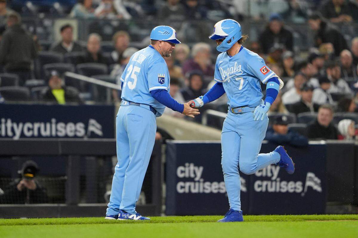 Kansas City Royals third base coach Vance Wilson congratulates shortstop Bobby Witt Jr. on his home run against the Yankees during a Monday, April 14, 2025 Major League Baseball game at Yankee Stadium in New York.