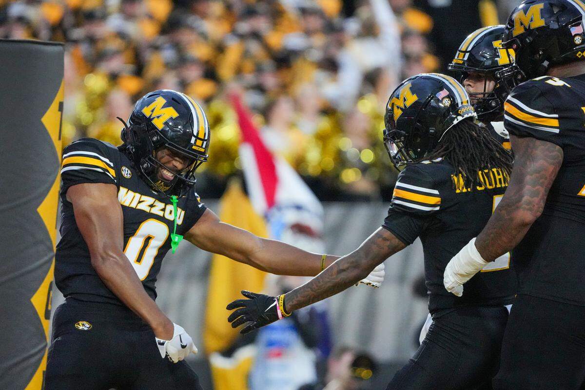 Sep 20, 2025; Columbia, Missouri, USA; Missouri Tigers wide receiver Joshua Manning (0) celebrates with team mates after scoring against the South Carolina Gamecocks during the first half of the game at Faurot Field at Memorial Stadium. Mandatory Credit: Denny Medley-Imagn Images