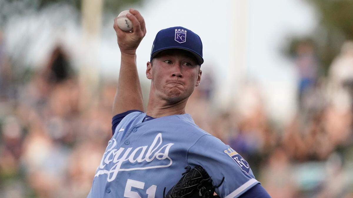 Kansas City Royals starting pitcher Brady Singer throws during the first inning of a spring training baseball game against the Los Angeles Dodgers on Saturday, March 26, 2022, in Surprise, Ariz.