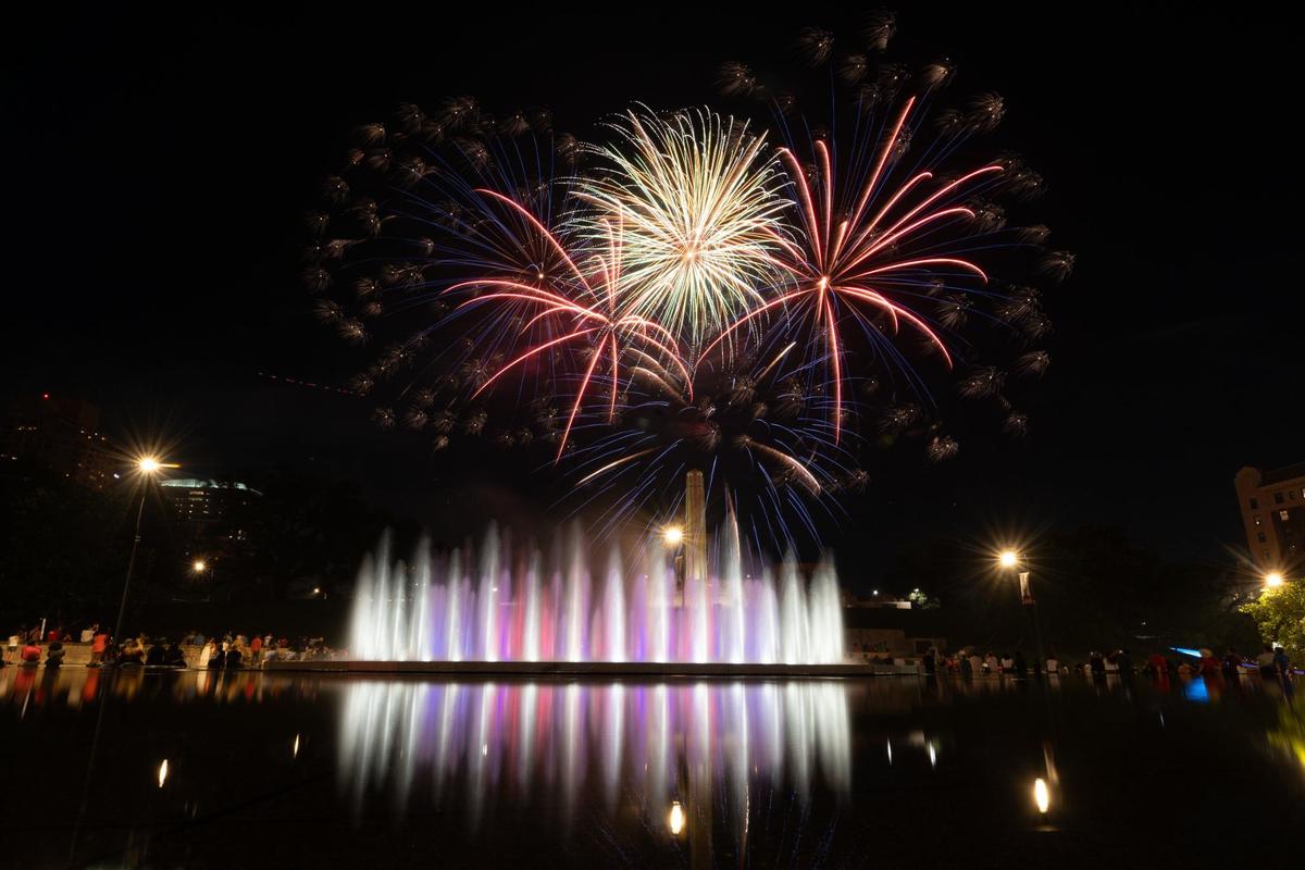 Fireworks burst over the tower at the National WWI Museum and Memorial and the Henry Wollman Bloch Fountain Thursday in Kansas City.