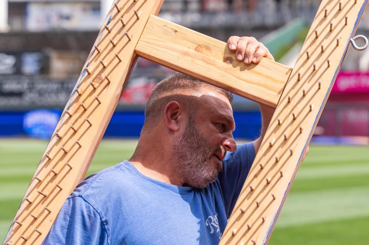 John Reed, Sr. Manager of the Royals grounds crew, switches out an infield rake attachment on the field at Kauffman Stadium on Tuesday, March 25, 2025.