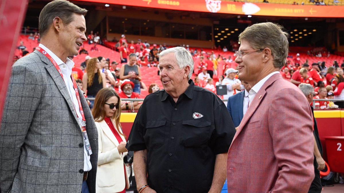 Kansas City Chiefs president Mark Donovan, left, and chairman and CEO, Clark Hunt, right, talk to Missouri Gov. Mike Parson on the sidelines before the Chiefs played a pre-season game with the Chicago Bears Thursday at Arrowhead Stadium. (082224, Arrowhead Stadium)