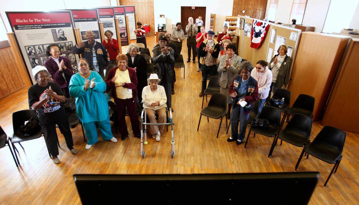 A small crowd watches as Barack Obama is sworn in as the nation’s 44th president Tuesday, Jan. 20, 2009 at the township hall Nicodemus, Kan. Nicodemus, a western Kansas farming community settled by former slaves after the Civil War, is now a national historic site. (AP Photo/Charlie Riedel)