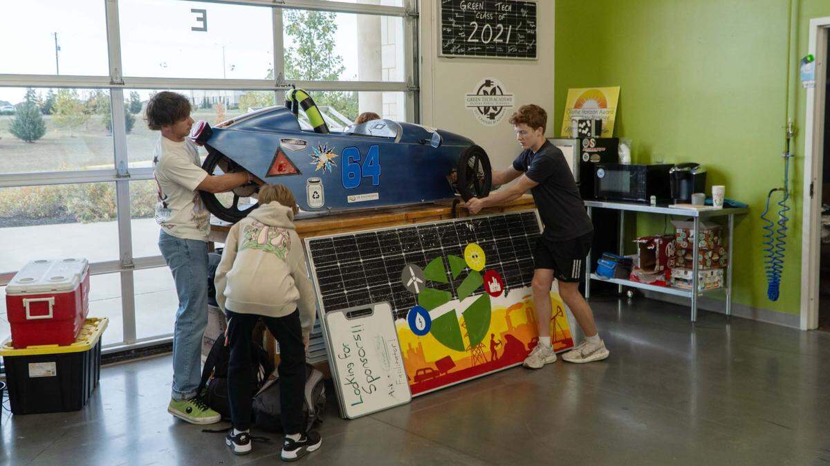 Alex Stone, left, Sloane Gieler and Eli Witters at the Green Tech Academy work on several projects, including this electric vehicle.