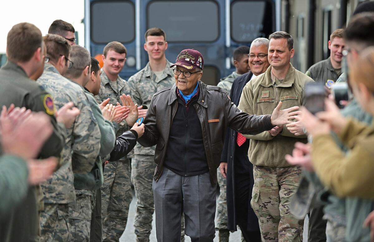 Retired U.S. Air Force Col. Charles McGee (center), a decorated veteran of three wars, receives a congratulatory a send off after visiting with 436 Aerial Port Squadron personnel at Dover Air Force Base to help celebrate his 100th birthday in Dover, Delaware, Friday, Dec. 6, 2019. McGee’s birthday is Dec. 7. (AP Photo/David Tulis)