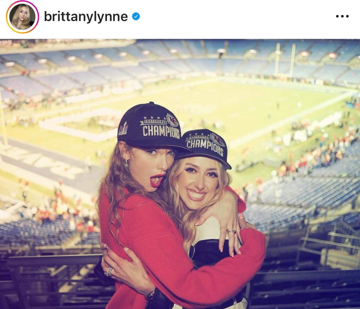 Taylor Swift and Brittany Mahomes in AFC Championship hats.