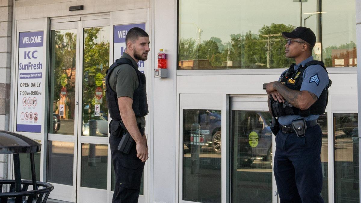Police and security officers stand at the entrance of the SunFresh Market Tuesday at the Linwood Shopping Center. Due to reports of crime and vagrancy, the shopping center has increased security and police presence.