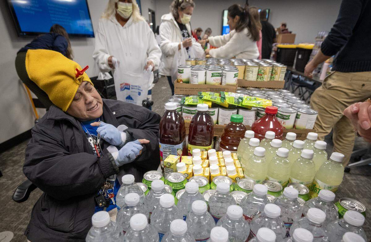 Maria Barrera, 62, a Jackson County resident, selected groceries during a monthly food distribution at Jackson County Public Health in Lee's Summit on Wednesday, November 19, 2025. The event aims to help address food insecurity among local residents by providing them with essential groceries.