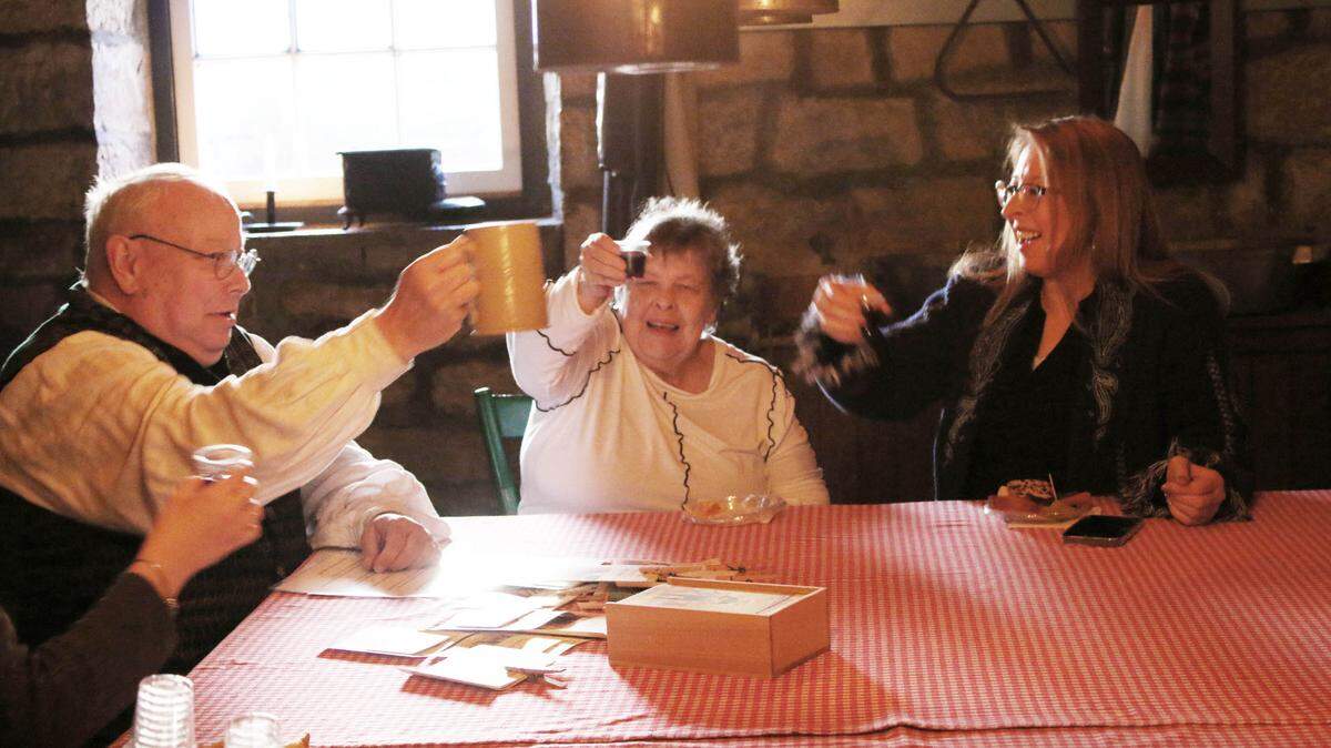 Historical interpreter Michael Maslak leads Donna Obrist of Kansas City and Jennifer Cisneros of Olathe in a toast praising George Washington in the cellar of the historical farmhouse at the Mahaffie Stagecoach Stop and Farm.