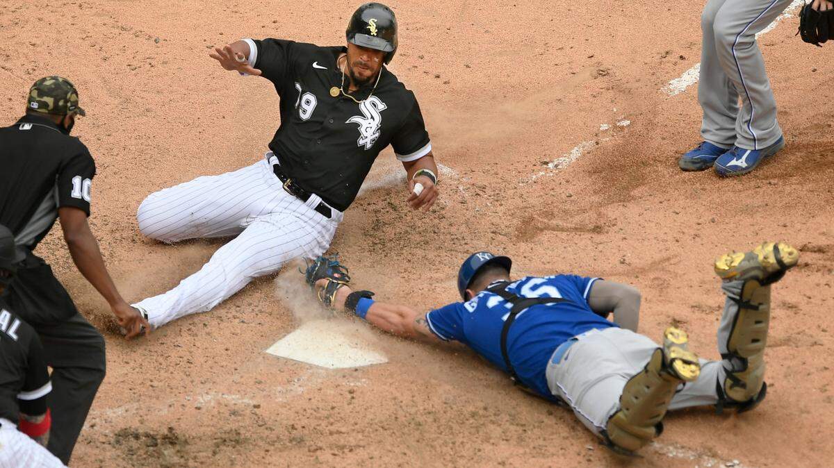Chicago White Sox’s Jose Abreu (79) slides safely into home plate while Kansas City Royals catcher Cam Gallagher attempts to apply the tag during the ninth inning of a baseball game Sunday, May 16, 2021, in Chicago. (AP Photo/Paul Beaty)