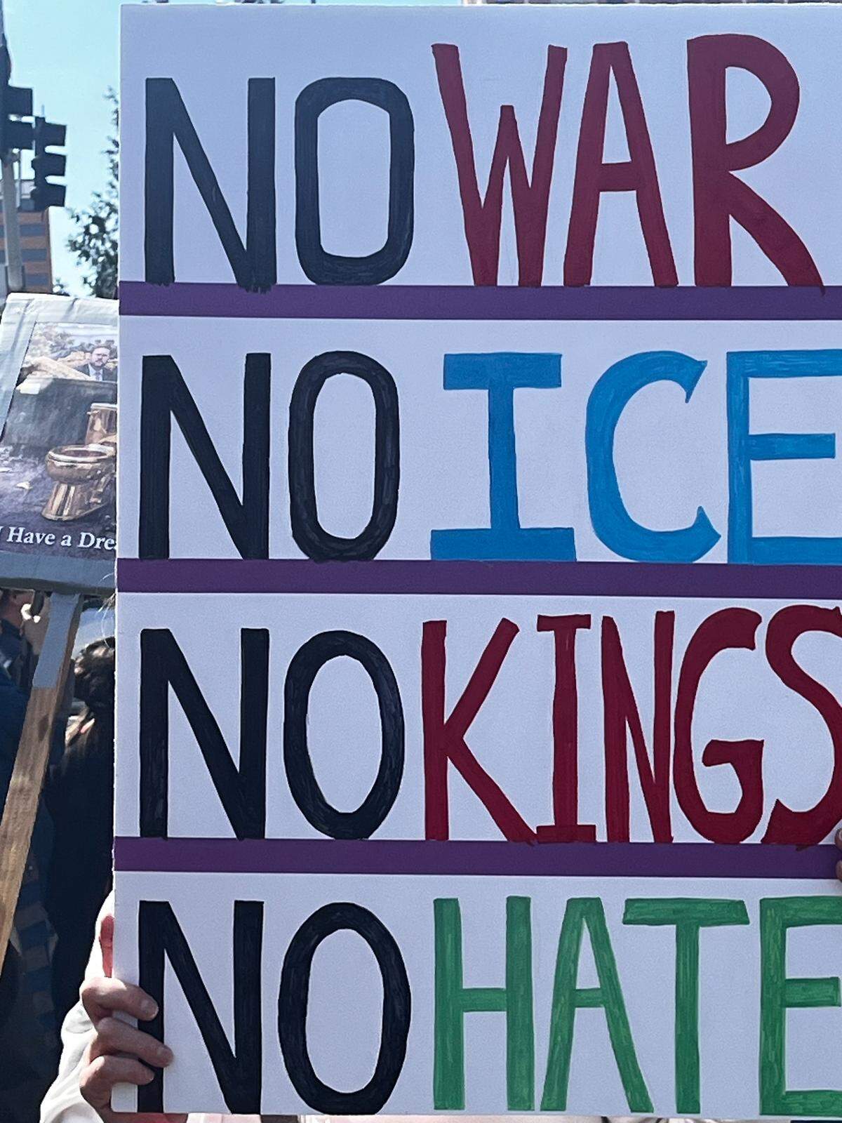 Thousands held signs protesting the Trump administration at a No Kings rally on the County Club Plaza in Kansas City, on March 28, 2026.