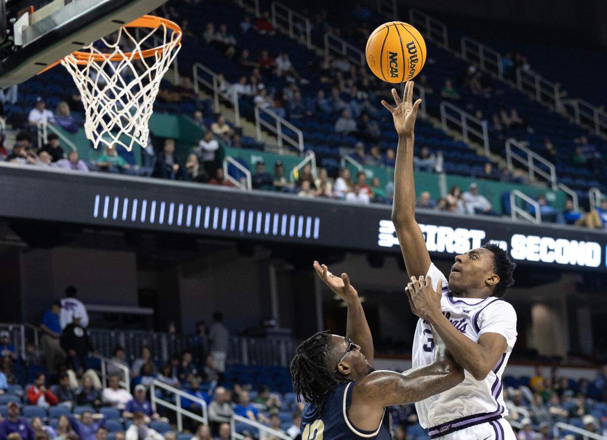 Kansas State’s Nae’Qwan Tomlin gets a shot off against Montana State’s Jubrile Belo during the second half of their first round NCAA Tournament game in Greensboro, NC on Friday night.