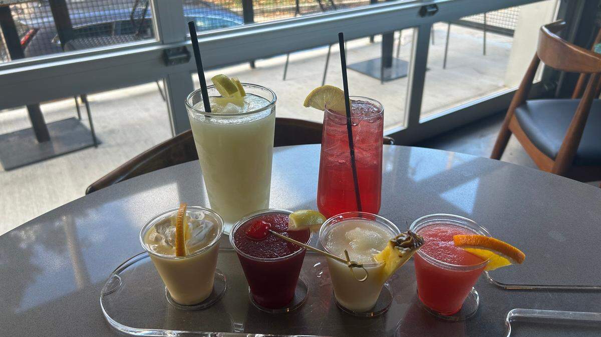 A sampling of the frozen drinks on offer at Frost, clockwise from top left: Citrus Freeze, Sparkling Strawberry Lemonade (nonalcoholic), Orange Creamsicle, Cherry Limeade (nonalcoholic), Pina Colada, Cranberry Mimosa.