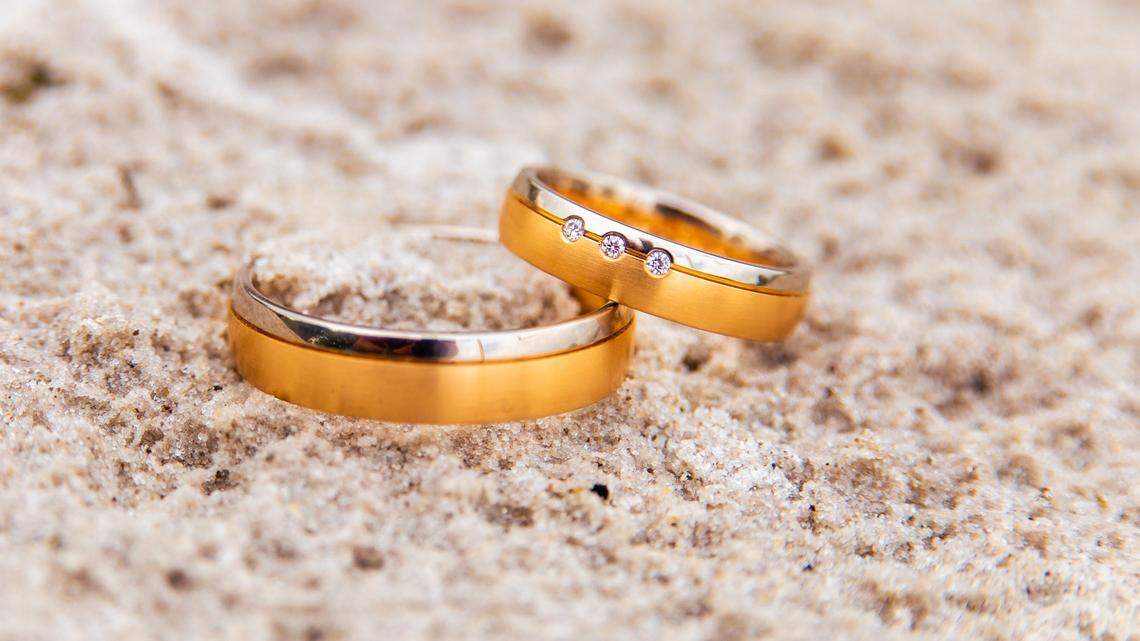 File photo of wedding rings in the sand. Authorities said a man from Michigan used government funds to pay for a boat wedding off the Florida coast. These were not his rings.