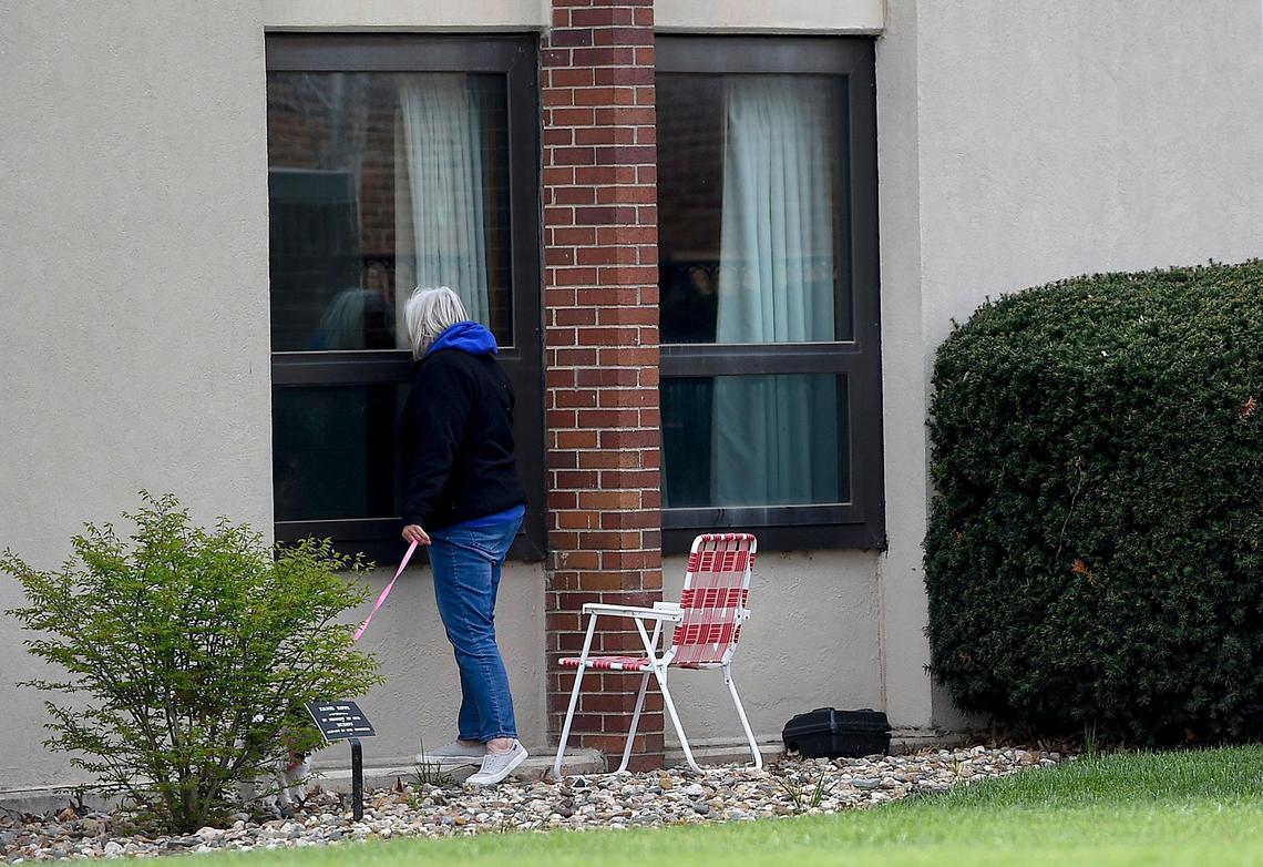 A woman looked into the window at Riverbend Post Acute Rehabilitation center in Kansas City, Kansas.
