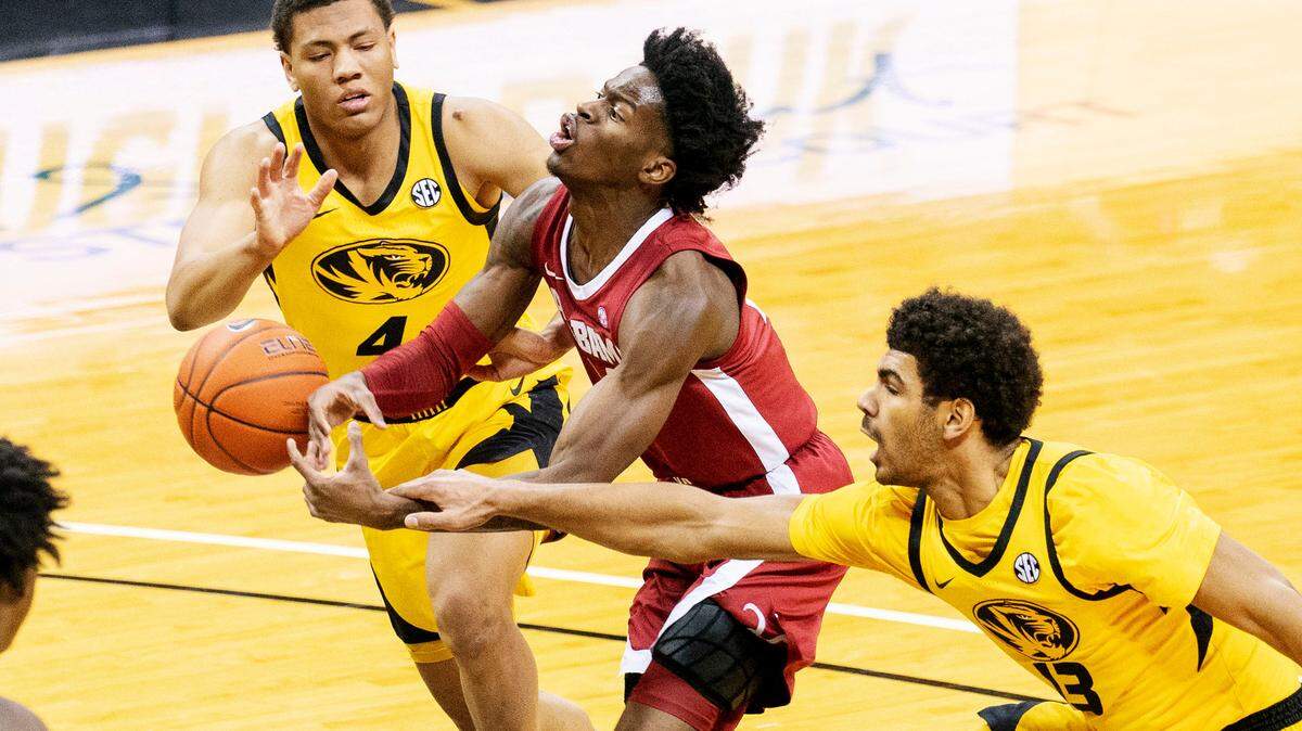 Alabama’s Keon Ellis, center, has the ball knocked away by Missouri’s Mark Smith, right, as Javon Pickett, left, moves in during the first half of an NCAA college basketball game Saturday, Feb. 6, 2021, in Columbia, Mo. (AP Photo/L.G. Patterson)