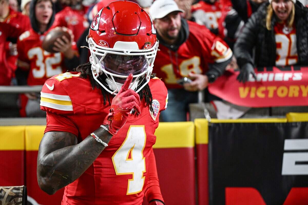 Kansas City Chiefs wide receiver Rashee Rice (4) gestures after handing off the football to a fan in the stands after running in a touchdown against the Washington Commanders in the fourth quarter on Monday, Oct. 27, 2025, at GEHA Field at Arrowhead Stadium.