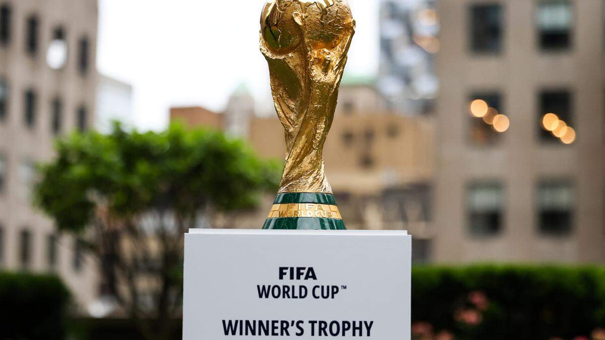 Jun 16, 2022; New York, New York, USA; The FIFA World Cup Trophy sits on a stand outside of 30 Rockefeller Plaza. Mandatory Credit: Jessica Alcheh-USA TODAY Sports