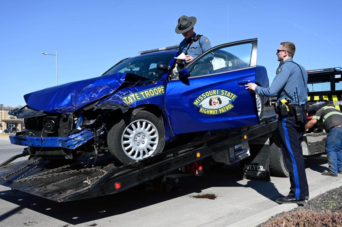 Missouri State Highway Patrol troopers look over a vehicle that was involved in a wreck during a pursuit by Kansas City Police at Missouri 210 Highway and Taney Street in North Kansas City. Kansas City Police were pursing suspects thought to be involved in a shooting earlier in the day when the wreck occurred. Two suspects were taken into custody after wrecking a stolen vehicle at Diamond Parkway and Taney Street.