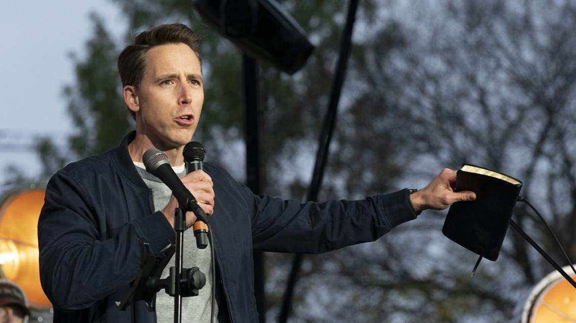 Sen. Josh Hawley, R-Mo., holding a Bible, speaks to a church crowd during a rally at the National Mall in Washington, Sunday, Oct. 25, 2020.