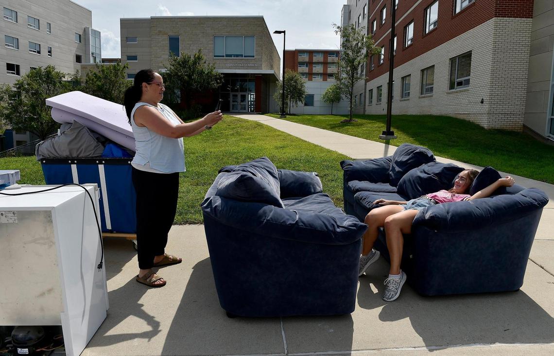 After the contents of a U-Haul were unloaded, Nichoel Johnston photographed her daughter Aubree Johnston taking a break. Aubree, a freshman majoring in English and dance, moved from Lee’s Summit into Oswald Hall at the University of Kansas on Tuesday. Instead of the usual crush of students moving into dorms, because of COVID-19 precautions, KU students were given an appointed time to stage their rooms days before they are allowed to actually move in.