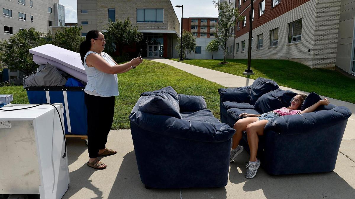 After the contents of a U-Haul were unloaded, Nichoel Johnston photographed her daughter Aubree Johnston taking a break during KU’s student housing move-in day in 2020.
