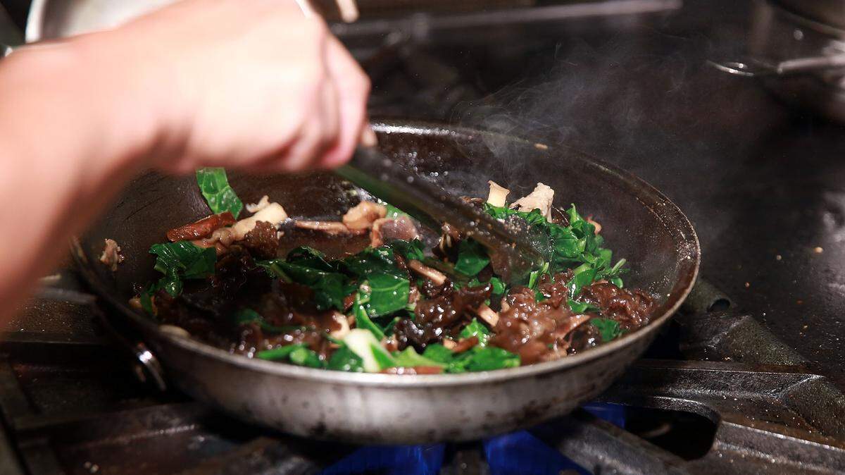 Cooking in a pan.