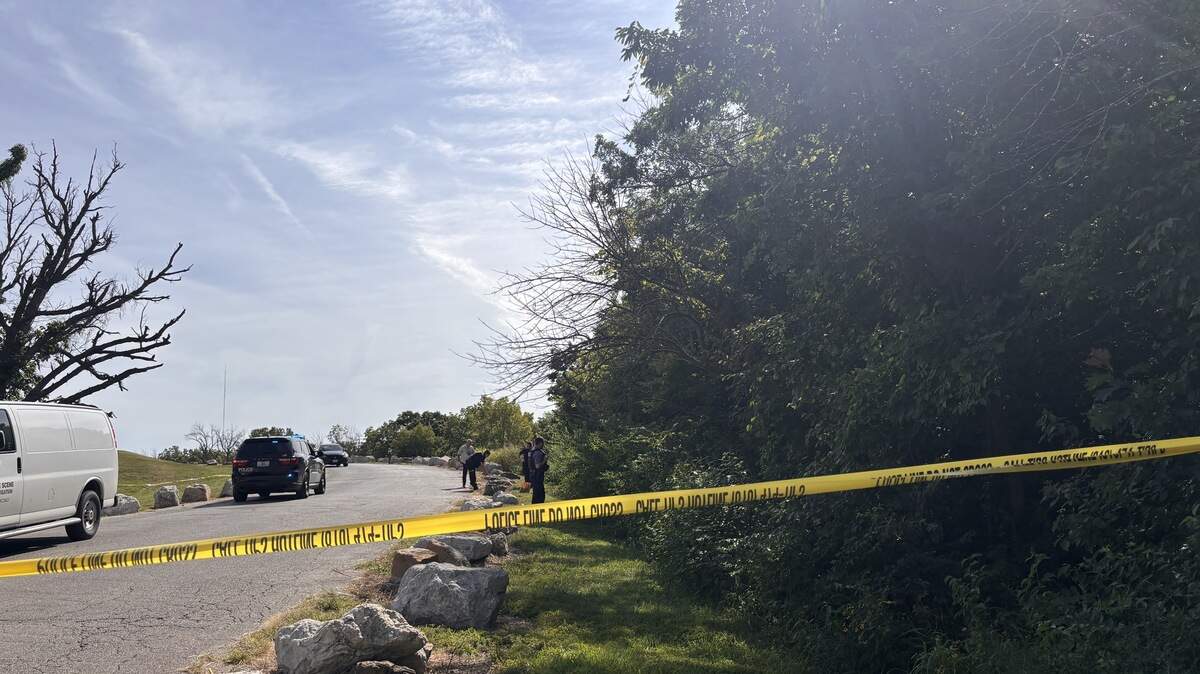 Crime scene tape surrounds the woods in the back of Kansas City’s Blue Valley Park, where a man was shot and killed Wednesday morning.