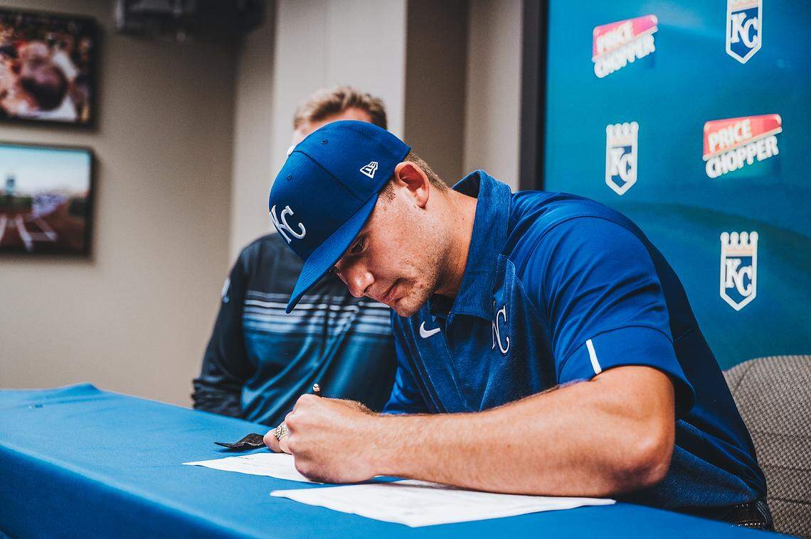 Kansas City Royals assistant GM/amateur scouting Lonnie Goldberg looks on as fourth overall draft pick Asa Lacy, a left-handed pitcher out of Texas A&M, signs his contract with the club at Kauffman Stadium on June 23, 2020.